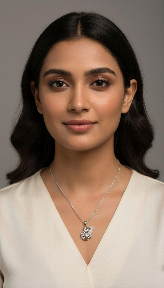 Woman wearing a silver necklace with a pendant against a neutral background