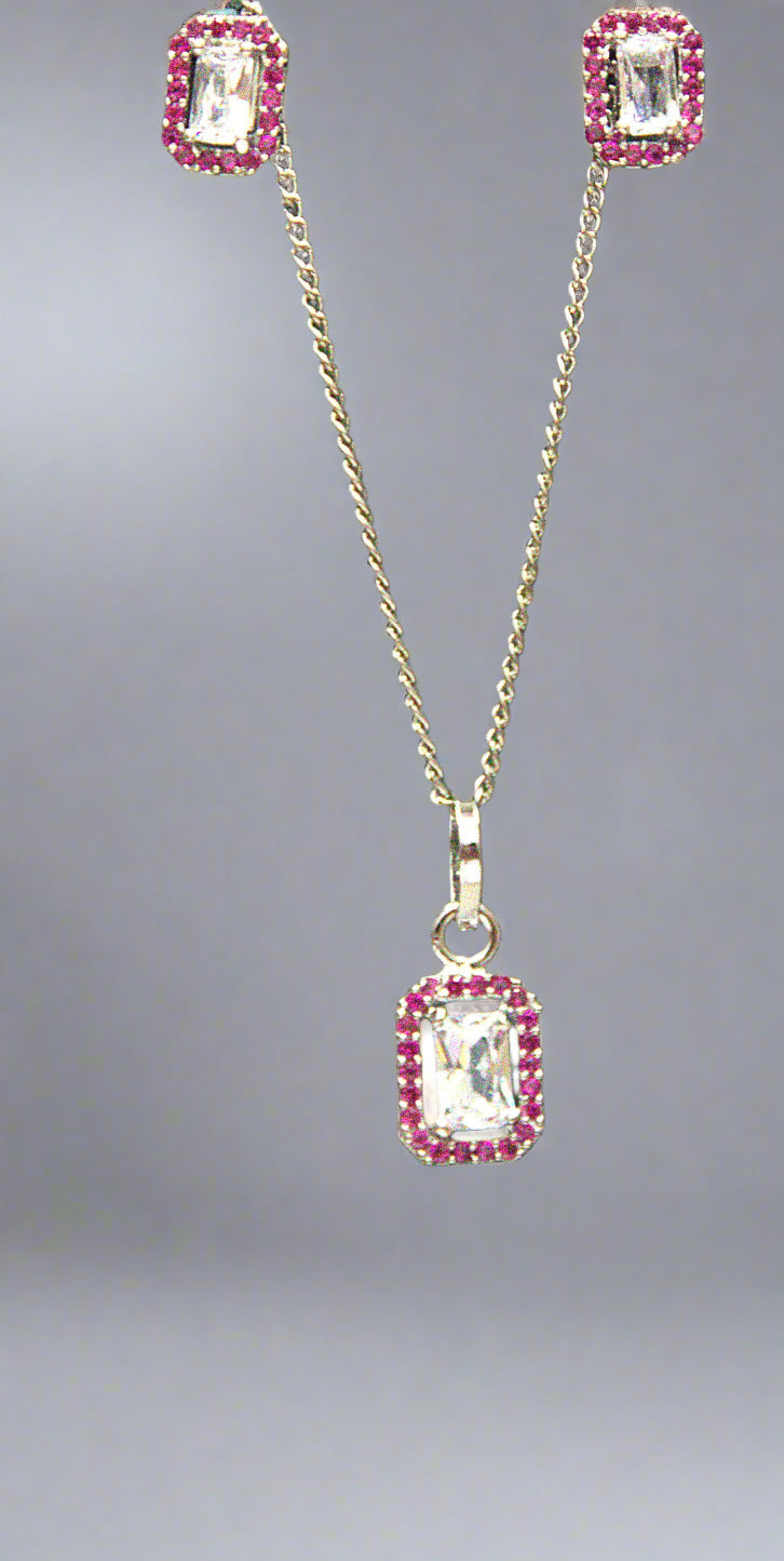 Jewelry set with pendant and earrings on a green background