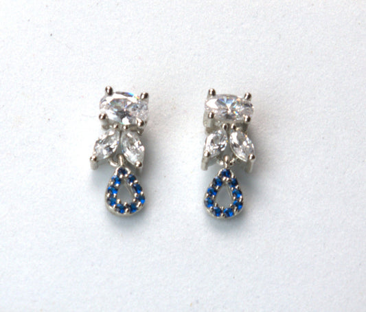 Pair of earrings with clear gemstones and blue accents on a white background