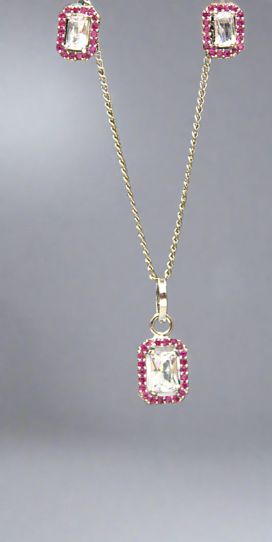 Jewelry set with pendant and earrings on a green background